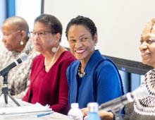 Group of people sitting at a table smiling